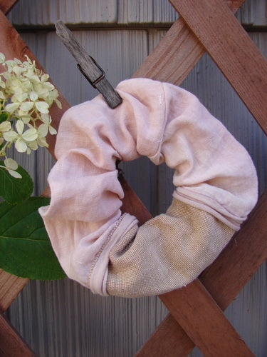 Barclay PMU Linen Hair Scrunchie Unpainted Textured Mauve One Size on a wooden fence, showcasing its ruffled fabric and thin elastic band, embodying Bluefishfinder.com's sustainable vintage style.