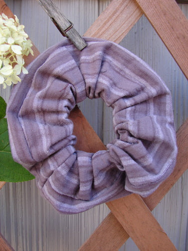 1999 PMU Organic Cotton Hair Scrunchie Unpainted Grey Plum Stripe One Size, featuring ruffled fabric and a thin elastic band, displayed on a wooden fence, highlighting its vintage, sustainable design.