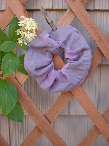 Barclay PMU Silk Linen Hair Scrunchie Unpainted Lavender One Size displayed against a wooden lattice, showcasing its ruffled fabric and forgiving elastic, embodying Bluefishfinder.com's sustainable vintage fashion ethos.