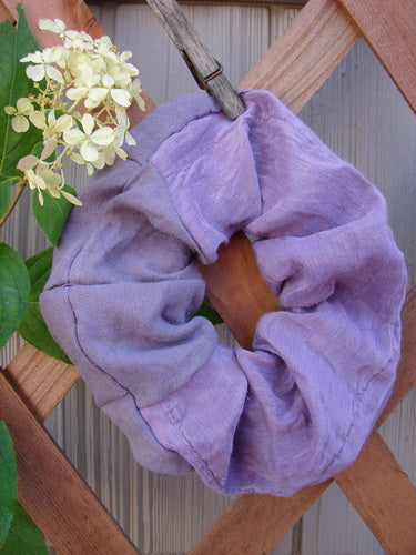 Barclay PMU Silk Linen Hair Scrunchie Unpainted Lavender One Size displayed on a wooden fence, showcasing its ruffled texture and soft, forgiving fabric, emphasizing sustainable vintage design from Bluefishfinder.com.