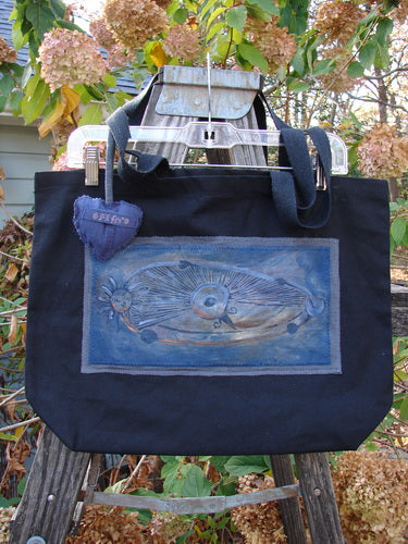 1998 PMU Patched Tote Bag showcasing a vibrant puffy heart patch, crafted from black canvas with extra-long shoulder straps. Features include a generous top opening and gusseted bottom.