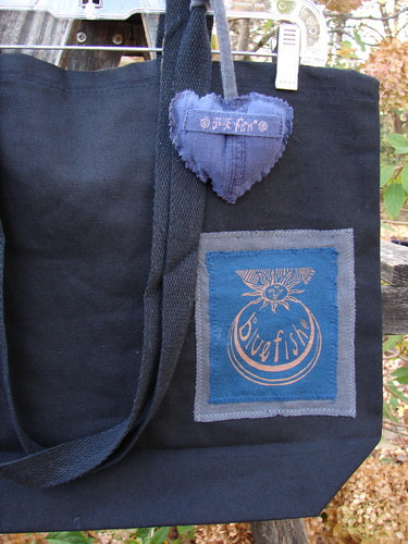 1998 PMU Patched Tote Bag Sling Sun & Wind Black One Size, showcasing a heart-shaped patch and signature patch on durable black canvas, featuring extra-long shoulder straps and a gusset bottom.