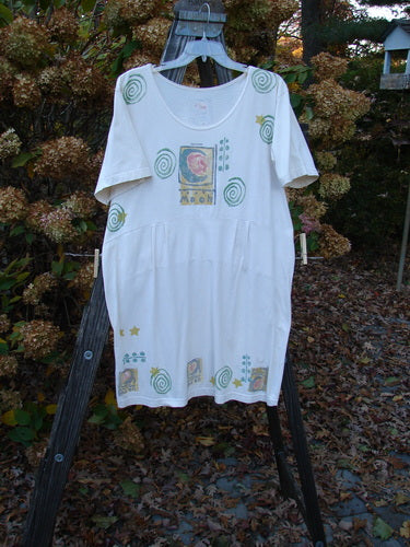 1992 Little Storma Dress Moon White OSFA: A white shirt with a graphic design on it, standing on a swinger.