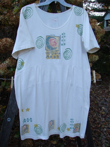 Image alt text: "1992 Little Storma Dress Moon White OSFA: A white dress with a pattern on it, featuring a deep rounded neckline, a downward curved front waist seam, and a drop lower rear waist panel. The dress is adorned with celestial moon-themed patches and the signature Blue Fish vintage patch."