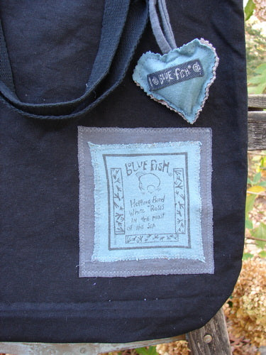 1994 PMU Patched Tote Bag Wood Path Black One Size featuring a colorful puffy heart accent, long shoulder straps, and a wooden path patch, celebrating Jennifer Barclay's sustainable vintage designs.