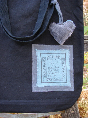 1994 PMU Patched Tote Bag Wood Path Black One Size featuring a puffy heart patch, long straps, and a gusset bottom, showcasing vintage-inspired designs by Jennifer Barclay for Bluefishfinder.com.