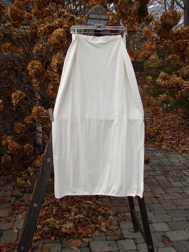 2001 Slim Slit Skirt on clothes rack, made of organic cotton. Flattering shape with side vents and rolled hemline. Size 2.