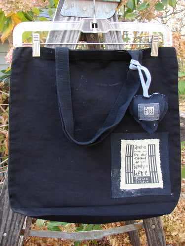 2000 PMU Patched Tote Bag Geos Black One Size, showcasing extra-long straps, gusset bottom, and a colorful puffy heart accent, reflecting Bluefishfinder.com's commitment to sustainable vintage design.