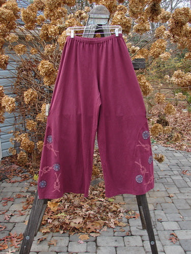 A pair of Barclay Hemp Cotton Empire Insert Pants in Stained Glass design. Full elastic waistline, generous rise, widening lowers, unique side panel insert, lower circle floral paint. Slimming fall with perfectly placed wheel theme paint. Size 2.