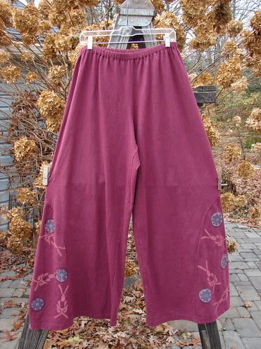 A pair of cotton pants with a unique side panel insert and circle floral paint design. Size 2.