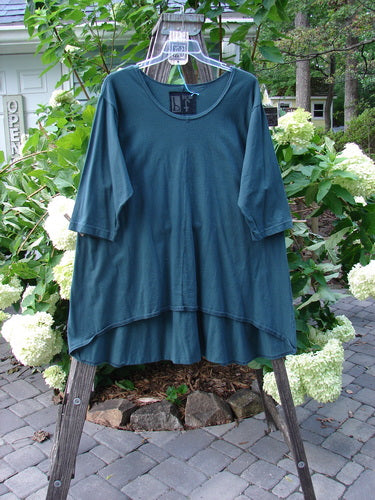 Barclay NWT High Low Top Unpainted Green Mineral Size 2 displayed on a clothes rack, showcasing its rounded bottom shape and feminine neckline.