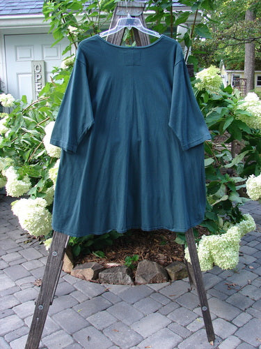 Barclay NWT High Low Top Unpainted Green Mineral Size 2 displayed on a clothes rack, showcasing its varying hemline and feminine neckline, perfect for mixing and matching.