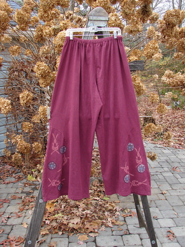 A pair of Barclay Hemp Cotton Empire Insert Pants in Stained Glass design, size 2. Full elastic waistline, generous rise, widening lowers, unique side panel insert, lower circle floral paint. Slimming fall with perfectly placed wheel theme paint.