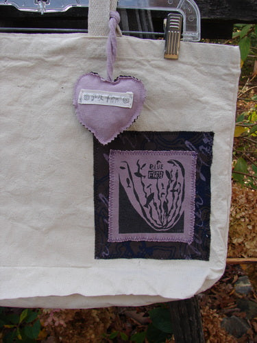 1995 PMU Patched Tote Bag Sling Vintage Logo Frayed Natural Lilac One Size, featuring a purple heart patch and cloth heart on a clothespin, crafted from heavyweight washed canvas with extra-long shoulder straps.