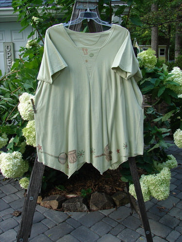 1994 Leaf Top Music Garden Aloe Size 2 displayed on a clothesline, showcasing its unique painted hemline, triangular neckline, and superior drape from the vintage Blue Fish Summer Collection.