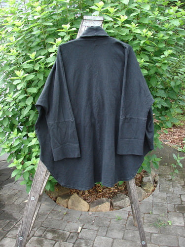 Barclay Reprocessed Golden Hour Deco Jacket Unpainted Black OSFA displayed on a wooden stand, highlighting its dense cotton fabric, unique dolman sleeves, and oversized diagonal pockets, embodying Bluefishfinder.com's vintage style.