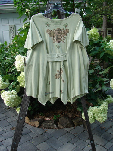 1994 Leaf Top Music Garden Aloe Size 2 on a rack, showcasing its unique painted hemline, triangular neckline, and flowing drape, part of Blue Fish's vintage summer collection.