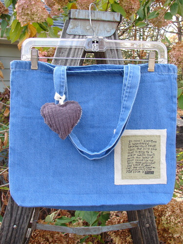 2001 PMU Patched Tote Bag Summer Frayed Logo Washed Denim One Size, featuring a distinctive puffy heart accent and tote-length shoulder straps, crafted from lightweight washed cotton denim for a vintage, sustainable style.