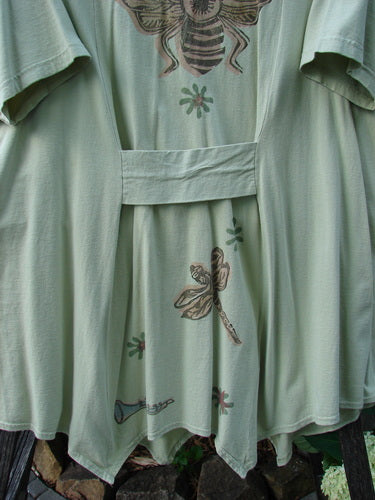 1994 Leaf Top Music Garden Aloe Size 2, featuring a triangular neckline, unique painted 4-point hemline, and superior drape with music garden theme paint, captured in a close-up.