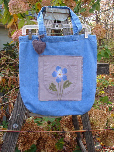 2000 PMU Patched Cotton Pocket Tote Bag Frayed Daisy Washed Denim One Size, featuring a flower patch, puffy heart charm, and tote-length straps, showcasing vintage-inspired sustainable design by Bluefishfinder.com.