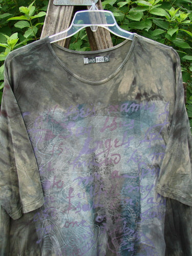 Barclay Tournesol Tunic Wind Script Mottled Green Earth OSFA displayed on a hanger, showcasing its loose three-quarter sleeves, rounded neckline, and varied hemline, embodying Bluefishfinder.com's vintage elegance.