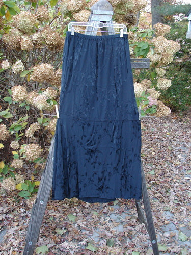 Barclay Brocade Willow Skirt Unpainted Black Size 2: A beautiful embroidered rayon skirt with a trailing floral pattern. Features a full elastic waistline, interesting side accents, and a uniquely paneled lower. Perfect for layering or as a standalone piece. Length: 40 inches.
