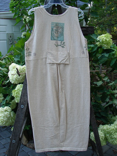 1995 Tab Jumper Magic Forest Natural Altered OSFA on a wooden rack, showcasing a scoop neckline, drop waist seam with a small pocket, vintage ceramic button, and rear painted tab.