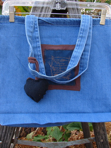 1998 PMU Patched Tote Bag Fall Quad Washed Denim One Size featuring a colorful puffy heart accent, tote-length shoulder straps, and gusset bottom, embodying Bluefishfinder.com's commitment to sustainable vintage design.