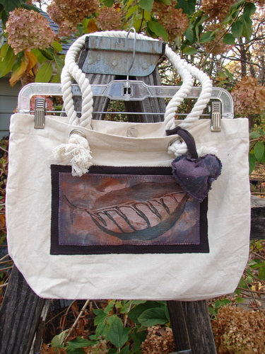 1998 PMU Patched Canvas Rope Pocket Tote Bag Ash Leaf Natural One Size features a white canvas with rope handles, a puffy heart, Blue Fish label, and an ash leaf patch, embodying vintage creativity.