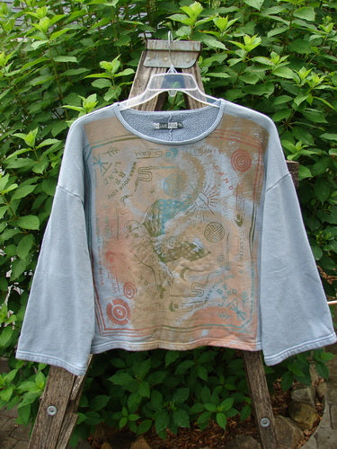 Barclay Fleece Crop Boxy Sweatshirt Blue Fish Land Trinket OSFA displayed on a hanger, showcasing its wide A-line shape, drop shoulders, and artistic blue fish pattern, emphasizing its cozy fleece texture.