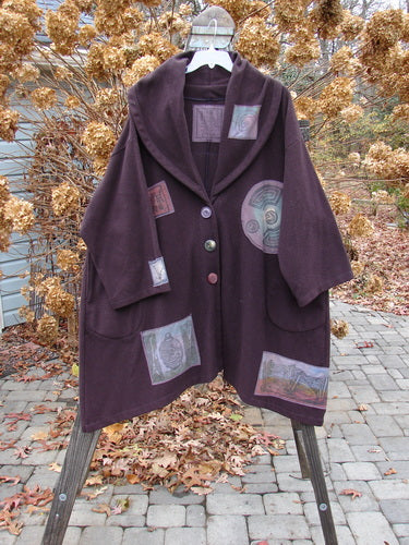 1994 Patched Wool Falling Snow Short Coat on a rack, with multi-colored patches, vintage Blue Fish buttons, and a shawl collar.