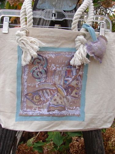 Barclay PMU Patched Canvas Rope Pocket Tote Bag Butterfly Natural One Size, featuring a butterfly design, cotton rope straps, gusset bottom, interior pocket, and Blue Fish patch, celebrating sustainable creativity.