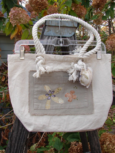 2000 PMU Patched Canvas Rope Pocket Tote Bag Daisy Natural One Size features a cotton rope handle, front pocket patch, and daisy patch, celebrating sustainable vintage design at Bluefishfinder.com.