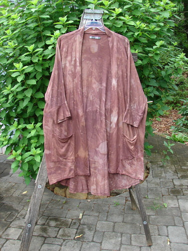 Barclay Bamboo Dolman Day Jacket Unpainted Mottled Autumn Copper OSFA, showcasing its open front, exterior drop pockets, dolman long sleeves, and a distinctive rounded rear hemline against an outdoor setting.