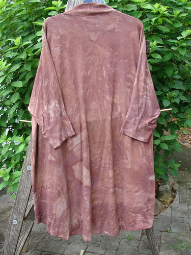 Barclay Bamboo Dolman Day Jacket Unpainted Mottled Autumn Copper OSFA displayed on a rack, highlighting its open front, dolman long sleeves, and unique hemline, reflecting BlueFishFinder's vintage style.