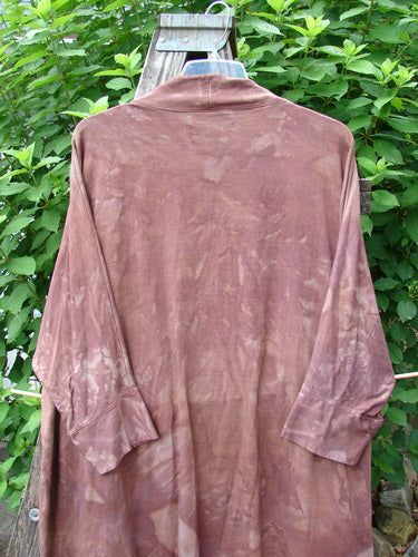 Barclay Bamboo Dolman Day Jacket Unpainted Mottled Autumn Copper OSFA on a hanger outdoors, showcasing its open front, dolman sleeves, and unique hemline, reflective of Bluefishfinder.com's eclectic vintage style.