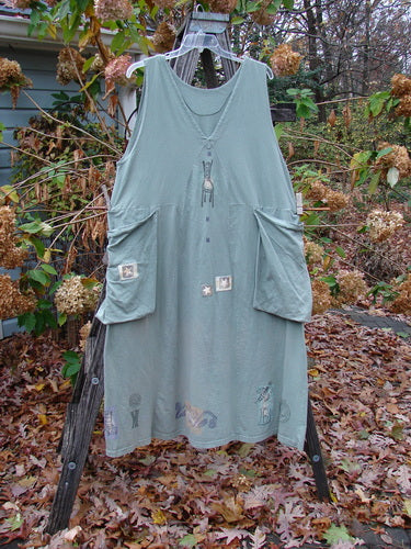 1994 PMU Patched Cross Smock Chair Garden Seaweed Size 2 displayed on a rack, featuring oversized pockets, a deep V neckline, and unique star patches, embodying Bluefishfinder.com's vintage charm and creativity.