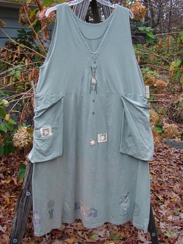 1994 PMU Patched Cross Smock Chair Garden Seaweed Size 2 displayed on a rack, showcasing its oversized stitched side pockets, deep V-neckline, and unique star patches.