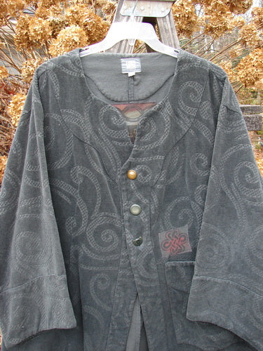 2000 Patched Upholstery Diwmach Coat Swirl Black Size 2: A grey jacket with a pattern on it, featuring colorful patches, vintage buttons, and belled, paneled lower sleeves.