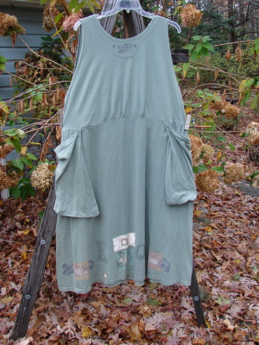 1994 PMU Patched Cross Smock Chair Garden Seaweed Size 2 displayed on a rack, featuring oversized stitched pockets, a deep V neckline, and unique star patches, embodying vintage Blue Fish style.