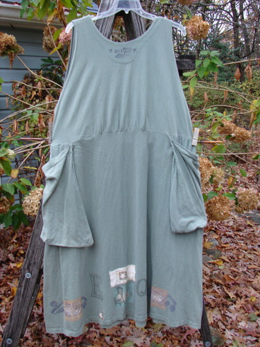 1994 PMU Patched Cross Smock Chair Garden Seaweed Size 2 on a rack, showcasing its oversized stitched pockets, deep V neckline, and star patches, embodying Bluefishfinder.com's vintage charm and individuality.