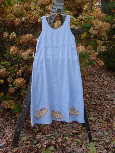 2000 Summer Shift Dress Fish Stream Size 1: A dress on a clothes rack, featuring a blue dress on a clothes line, with leaves on the ground.