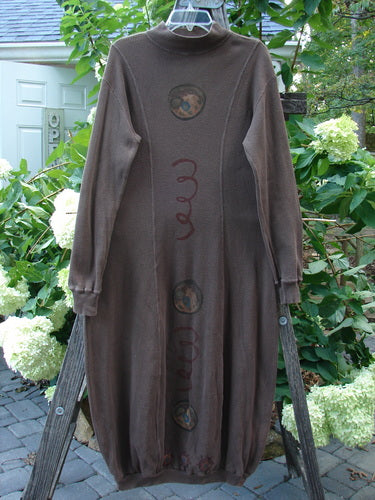 1996 Thermal Day Dress Celestial Molasses Size 0 displayed on a wooden rack, showcasing its hourglass shape, ribbed cuffs, mock rib T-neck, and celestial-themed paint accents.