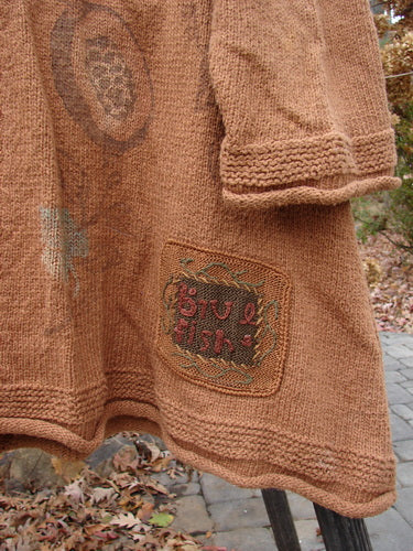1998 Rocky Mountain Raglan Sweater featuring a close-up of a brown fabric patch.