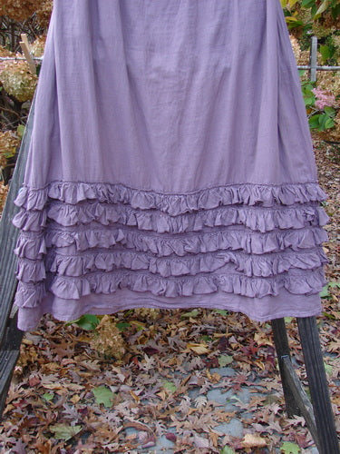 Barclay NWT Voile Fold Over Five Ruffle Skirt, Dusty Lavender, Size 2. A light purple skirt with a thick fold-over waist panel and a ruffled five-row paneled hemline.