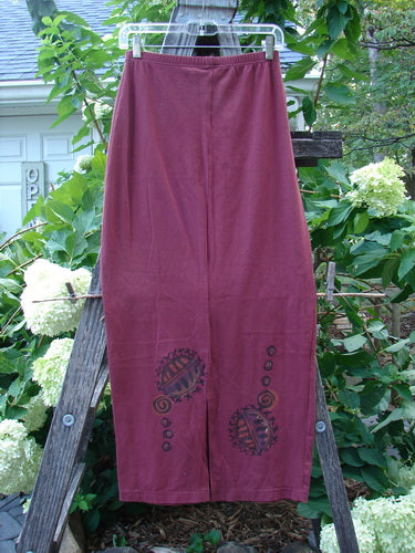 1996 Cotton Lycra Column Skirt River Rock Cayenne Size 1 displayed draped over a wooden ladder, showcasing its tapered shape, pegged hemline, and painted River Rock theme design.