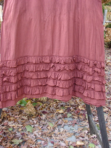 Barclay NWT Voile Foldover Five Ruffle Skirt, dusty clay, size 2, on a clothes rack. A billowy, ruffled skirt with a foldover waist panel and a sweeping A-line shape. Perfect for building a special look with delicate textures.