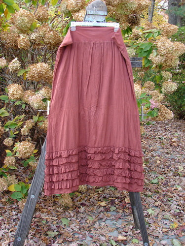 Barclay NWT Voile Foldover Five Ruffle Skirt on wooden stand, close-up of woman's skirt, and dress with ruffled hemline.