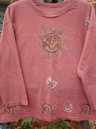 1991 Long Sleeved Tee Sun Guy Brick OSFA features a whimsical sun and spiral design, capturing the vintage charm of Blue Fish Clothing. Ideal for expressing individuality and creative freedom in fashion.