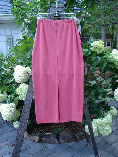 1996 NWT Cotton Lycra Column Skirt Unpainted Oriole Size 2 displayed on a wooden ladder, showcasing its slim, tapered design and back kick vent.